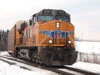 A solo UP loco pulls an autorack train East from the East end of Quebec Street Yard.