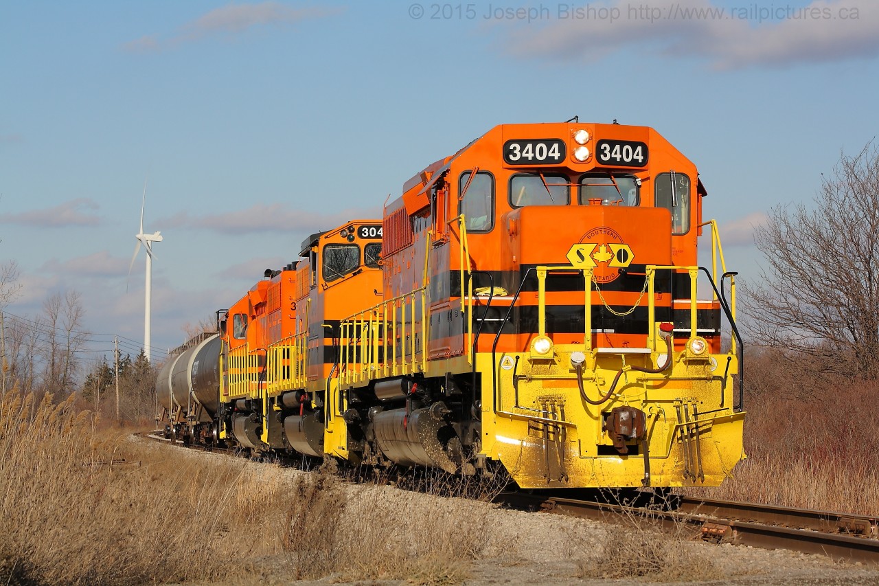 SOR 595 slowly approaches the Haldimand Road 3 crossing in Nanticoke Ontario with RLHH 3404, RLHH 3049 and RLHH 3403.  They have three cars for the US Steel Lake Erie Works which is located right behind the photographer.  The crew would wye their power within US Steel before emerging to begin building their train for Paris.
