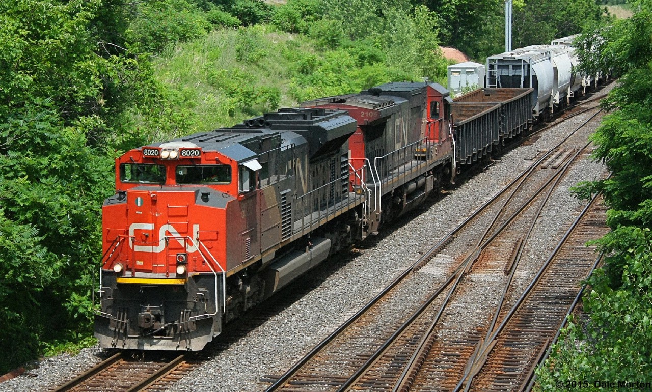 CN SD70M-2 #8020 with C40-8 #2105 pull out of Aldershot yard, and under the Snake Rd. bridge in Burlington Ontario, in July 2012.