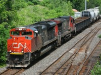 CN SD70M-2 #8020 with C40-8 #2105 pull out of Aldershot yard, and under the Snake Rd. bridge in Burlington Ontario, in July 2012.