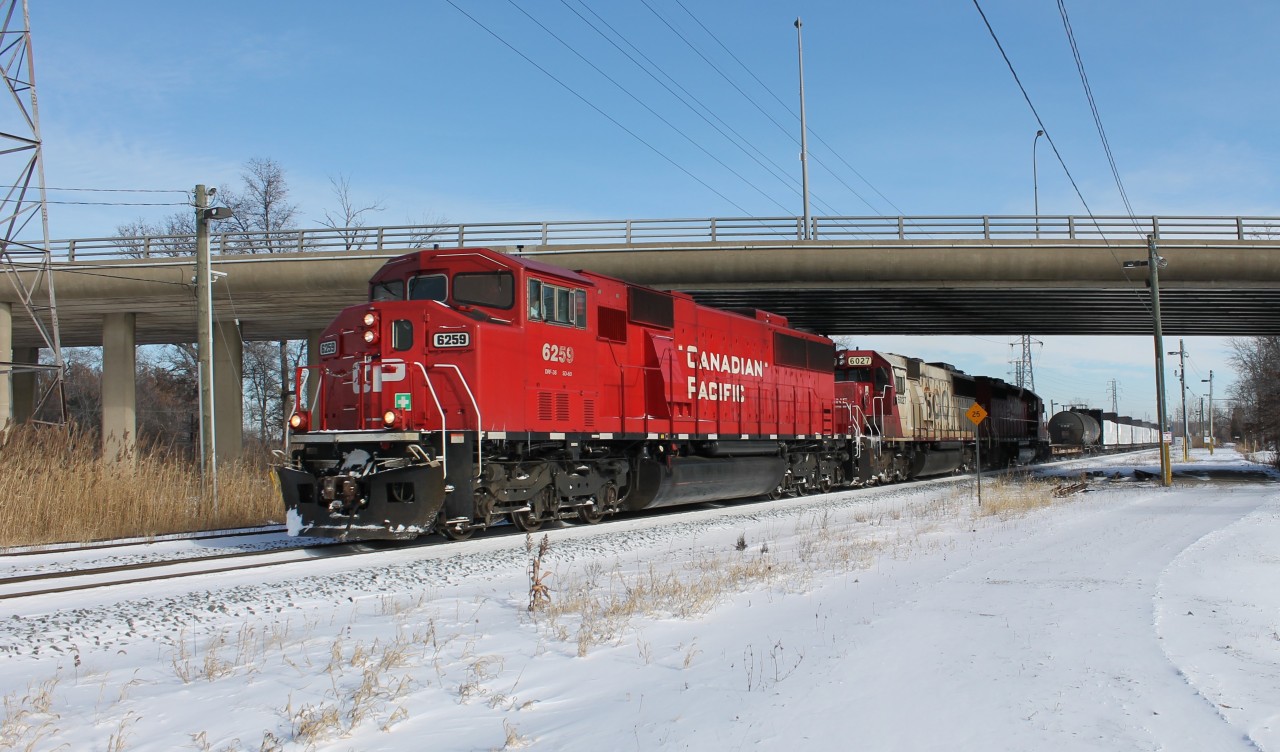 I was coming home from bowling on Saturday and I decided to drive next the CP tracks near my house to see if anything was coming. I'm lucky I did as I saw this pulling up to the Walker Rd. underpass to get ready for its slow trip through the VACIS machine. I drove home, grabbed my gear and went down to the Ouellette overpass in-between Dougall (behind the camera) and McDougall. I waited for about 15-20 minutes in the cold and it finally came. This is fairly rare for this train as it usually has 3 SD40-2s. Hopefully this power sticks around here as this is a local NS and CSX transfer from Windsor to Detroit and back.