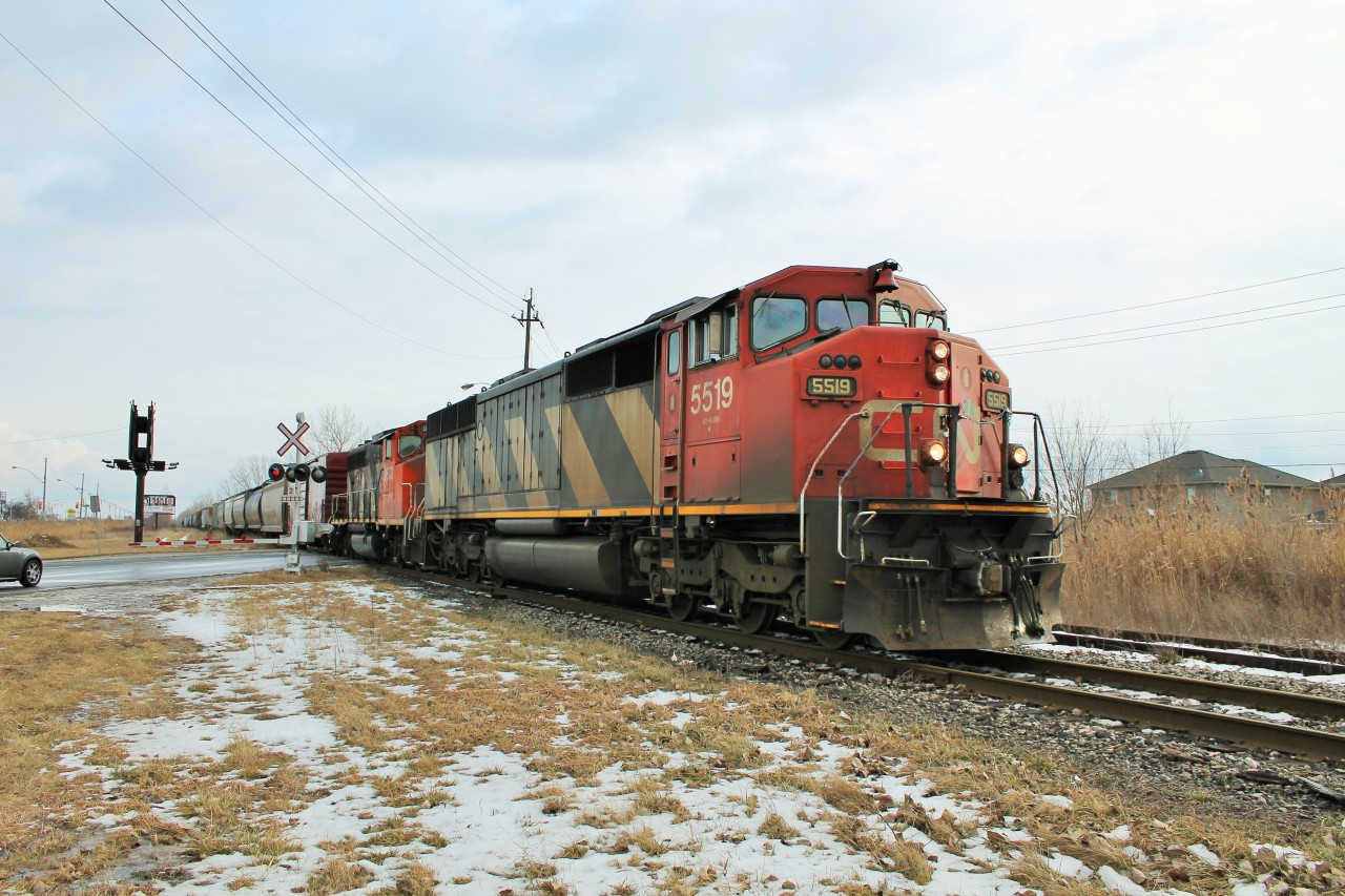 I was out train-watching yesterday before work and there was nothing on CP so I checked out CN and sure enough CN 439 was coming. I ended up catching it at two locations in the city, this being Howard Ave. The crew is getting ready to take their neck braces off as they head towards CN Van De Water Yard on this very bumpy section of track. Just before the crossing the engines were rocking so violently I thought they were going to derail.