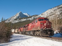 After waiting for three westbounds at Banff, this empty grain train continues east towards Calgary. About to approach the hamlet of Exshaw. 