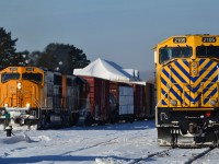 with idling 2105 in the foreground, southbound 214 throttles up out of Englehart.