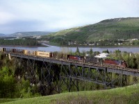 Railinks Mackenzie Northern Railroad train 561 from Edmonton to Hay River NWT crosses Heart Creek as it descends into the Peace River Valley south of the town of Peace River