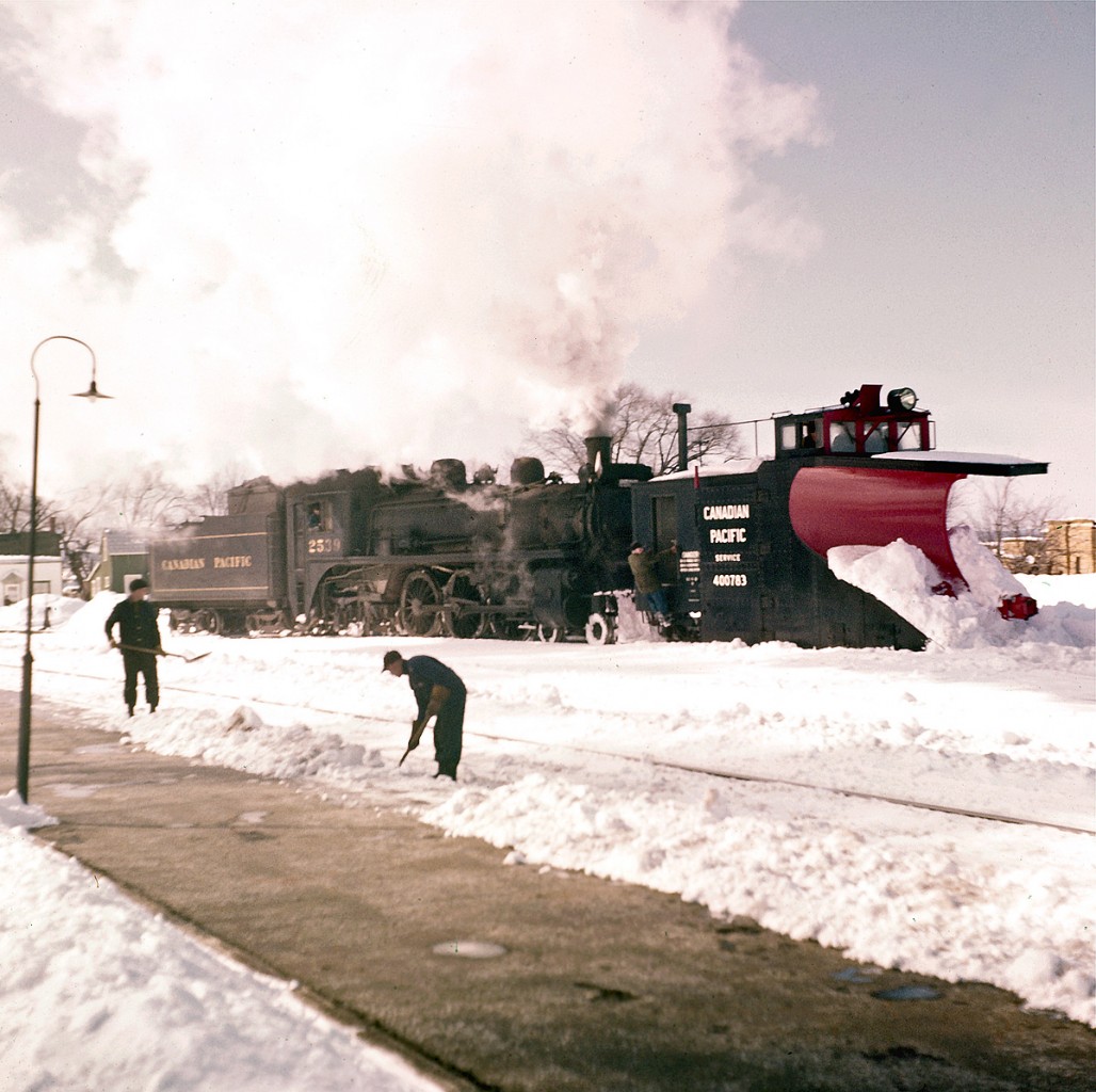 It looks like Pembroke had quite a snowstorm!  The crews are out in force and I’m guessing that it won’t be long before the tracks are clear again.  The late Del Rosamond captured this photograph at the Pembroke CPR stone station, circa 1959.  


For many years I’ve studied this image.  The focus is very soft – almost like a Wentworth Folkins water-colour painting.  You’ll notice that the faces of the men shoveling the snow have no definition… kind of ghostly in an intriguing way.