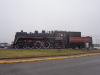 The iron fence and shrubs are cleared away, and QNS&L 702 4-6-2 has been cosmetically freshened up for all to see at the passenger station in Sept-Iles, Quebec on this cool, overcast and drizzly late October morning.