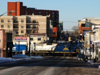 RLK 4003 and CEFX 1569 navigate their way through the streets of downtown Brantford, ON with two hoppers from Ingenia
