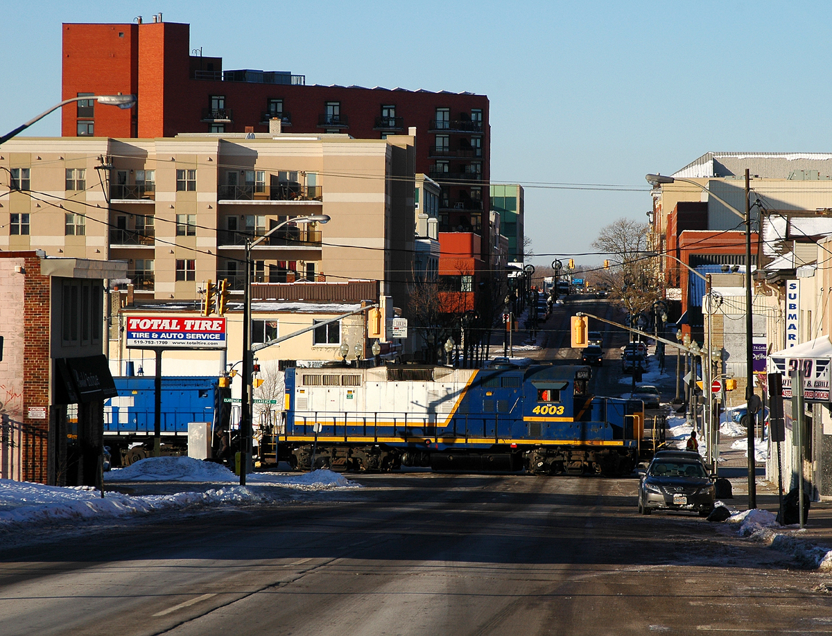 RLK 4003 and CEFX 1569 navigate their way through the streets of downtown Brantford, ON with two hoppers from Ingenia