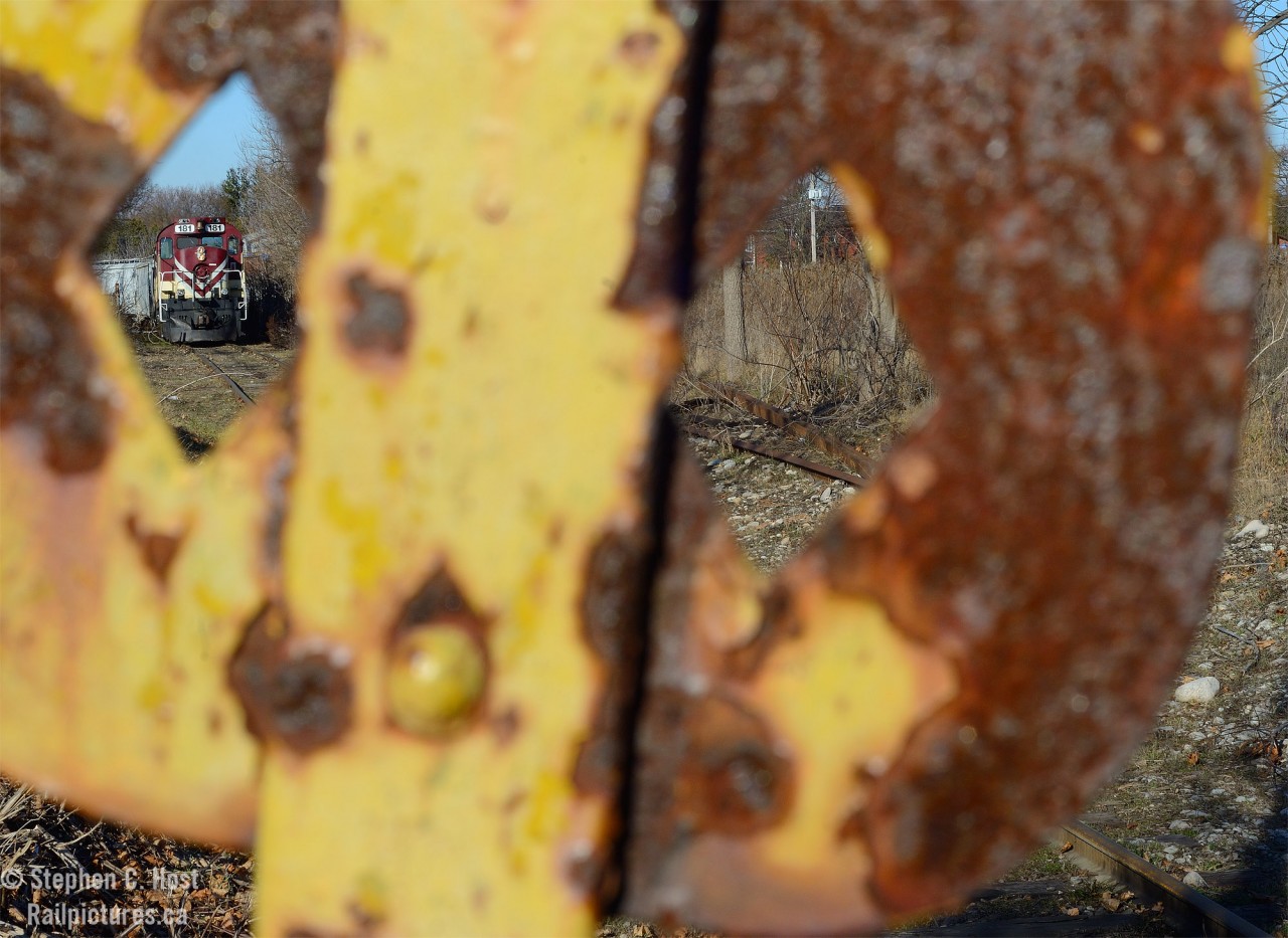 Something a little different - An old cast iron restricted clearance sign stands guard as it has for the last 100 plus years while a pair of MLW's switch Chemtura, former Uniroyal on the Fibreglass lead.