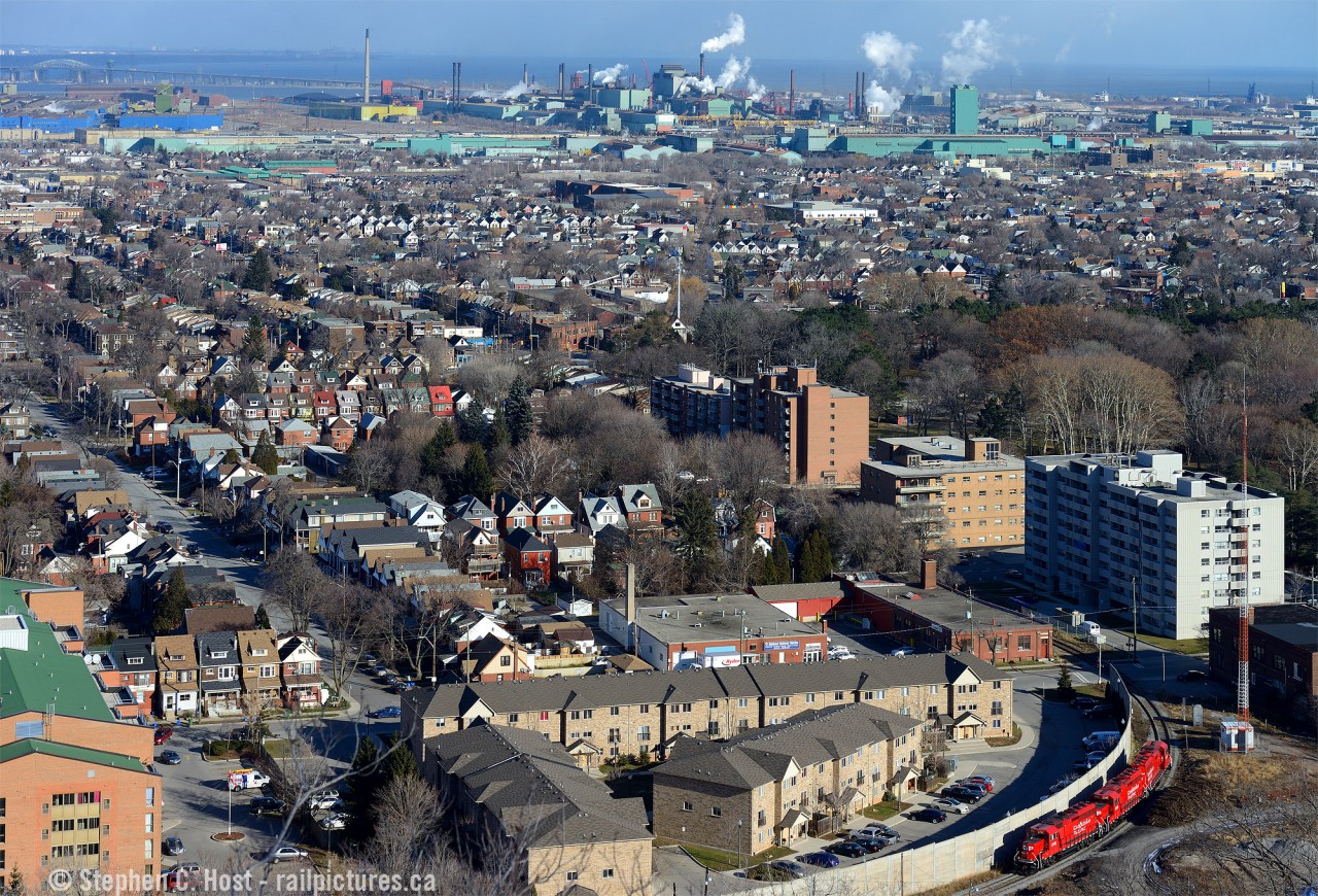 The time is 11:36. The third of three images of my 36 minutes of action and my last train photo of 2014. I realized fairly quickly after I was done with US Steel/Stelco that I could make it up here for my last angle. Could I do it? Light traffic for the holiday season made it possible. In this scene TH31 is about to finish for the day arriving at Kinnear Yard light power - the four cars seen earlier must have been set off in Adams Yard (by Ottawa and Burlington St).At top left- just under the Burlington Skyway - those blue buildings is US Steel and is exactly where I was less than 15 minutes earlier. The outbound yard is just to the right of the blue buildings and if you squint just right you can see six railway cars in the yard. Top Middle is Dofasco.  And at top right? That's National Steel Car (With Centre Mall in front) and my  first photo in this 36 minutes of action was taken just off the screen.