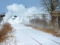 <b>VIA steals the show in the Snowbelt...</b>It's been 5 hours since the last passenger train, and mother nature is angry. It's cold, -15C, the prevailing winds are blowing from Lake Huron at about a continuous 40 KM/H and as a result the snow on the ground drifts. Boy does she drift - what you see accumulated on the track is 3-4 foot high, 1500 foot long drifts of just snow. Five hours? Imagine what happens overnight! That's why we have plows on GEXR and OSR in Ontario. Formula for plowing on Ontario: Viscous (non frozen solid) Snow on the ground + Continuous wind (30+ kph sustained for hours at a time) and no train for a while = Snowplows. Or in this case, you do have VIA.. <br><br>In the distance I hear the continuous, muffled sound of a familiar horn and soon you see puffs of white stuff appear down the track, growing ever closer. For brief moments, and I mean really brief moments, the nose of a VIA locomotive peeks through the plume - enter Evidence A above. The vast majority of photographing a VIA train plowing through a long cut of drifted snow is just a plume of white. Why though? 6437 lacks blades and wings like those on a snowplow which would effortlessly throw snow in either direction, by which, the crew would (mostly) retain visibility in the high plow cab. :) VIA engineers see nothing but white, the horn is left on continuously or you'd plug it up and render it useless, plus you do have a crossing coming up <br><br><br>Believe it or not GEXR 518 followed this train.. with a snowplow extra but VIA clearly stole the show. <br><br>For a limited time - prints of this photo are available at Fine Art America <a href=http://fineartamerica.com/featured/via-rail-train-plowing-through-snow-20150109-stephen-host.html>here </a>