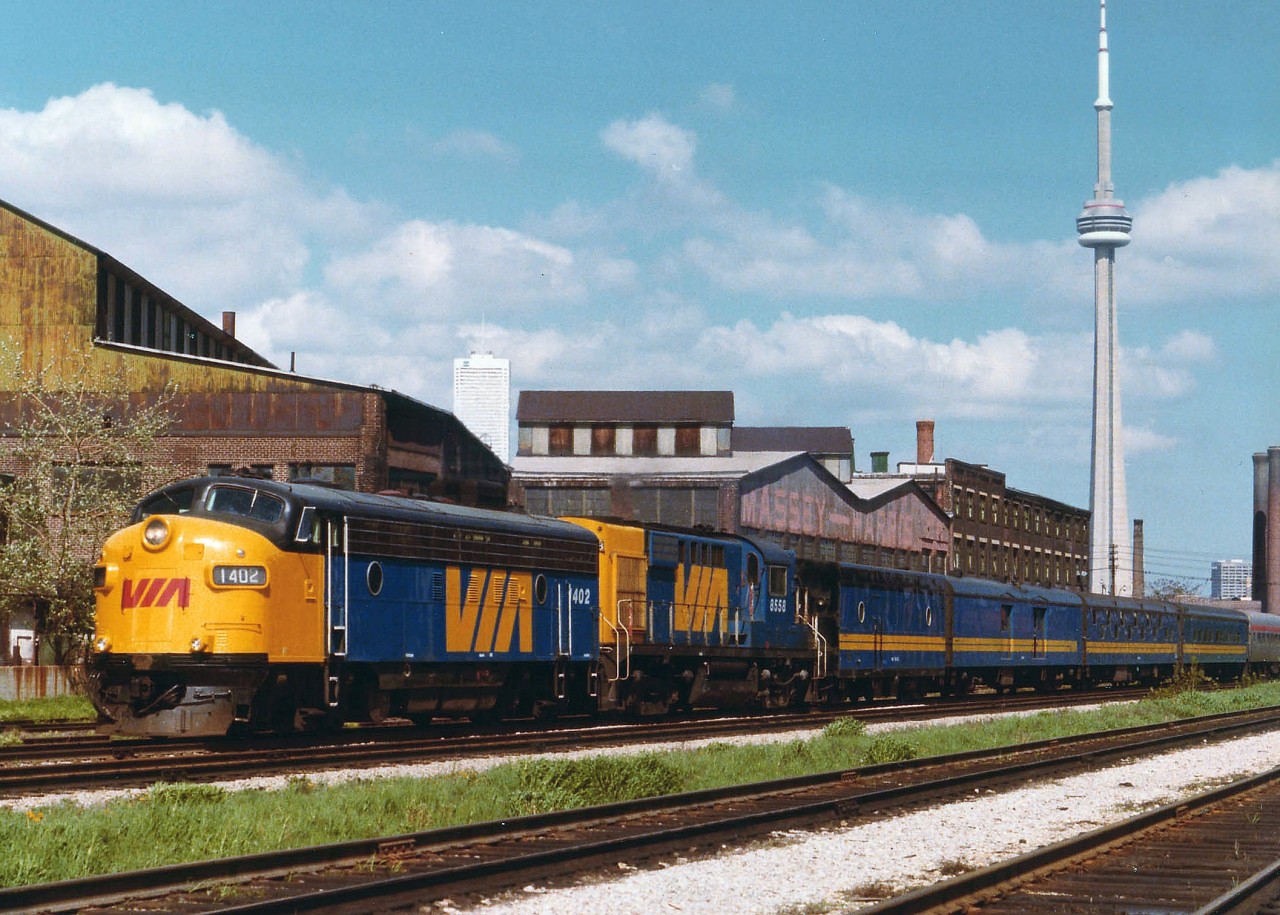My information on exact location and train number scanty due to misplacing necessary information around here; as the CN Tower looks as though it was "planted" just to spruce up the image. Not so. A lot of changes along the Toronto waterfront areas since this photo was taken back in 1979. The "Canadian" has only been running in its first year out of Toronto, and links up with the Transcontinental version at Sudbury. Lead unit VIA 1402, former CP 4101, along with one of a kind MLW RS-10 x-CP 8558, makes for a most unusual power combination. The 1402 was retired in 1983, the 8558, never really accepted, was gone by 1981.