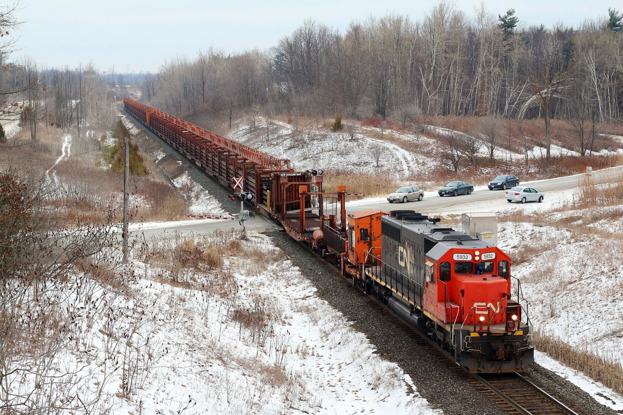 This loaded welded rail train was hot on the block of CN 435 as it rolls past mile 30 with CN painted GTW 5932 up front and a well weathered GTW caboose on the tail end.