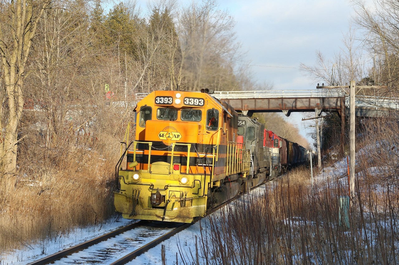 There's no place to go but up, as Goderich - Exeter train 431 digs into the Halton Hills and Niagara Escarpment at the small village of Limehouse. The trains power of elderly EMD's are beginning to roar as they try to maintain something close to track speed as they pass the one time station site near the old steel road bridge .