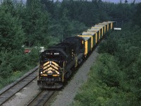 CBNS C630 2039 leads train #408 through Edwardsville, just east of the switch to the Point Edward spur. There is a cut of empty Devco hoppers on the head end, they carried coal loads west to the power plant at Point Tupper (or maybe Trenton) and will return to the wash plant at Victoria Jct. for loading.
