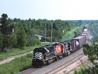 New Brunswick East Coast train #403 on the return leg of its daily turn from Campbellton to Miramachi rolls through Beresford, under Acadia St. At this time chasing #403 required full use of the speed limit on Highway 11 and only resulted in a few shots between Bathurst and Campbellton. 