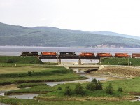 New Brunswick East Coast train #403, lead by CFMG SD40 6907, is almost back home in Campbellton after making a turn to Miramachi. The hills in the distance are in Quebec.