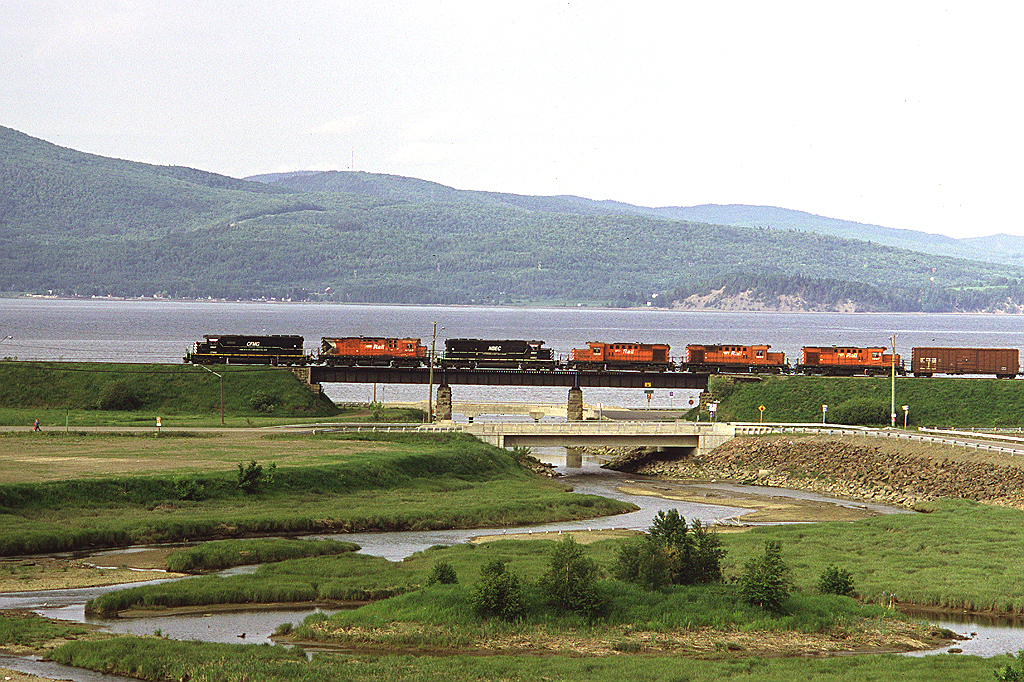 New Brunswick East Coast train #403, lead by CFMG SD40 6907, is almost back home in Campbellton after making a turn to Miramachi. The hills in the distance are in Quebec.