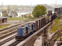 Unfortunately this old scene is a bit grainy, but one can see the daily Conrail transfer to Fort Erie from Buffalo stretches all the way back past the customs on the American side. This location has changed so much in the past 35 years since I wandered up on the Central Av overpass to bag this photograph. That modern CN/CP/MCR station on the left was boarded up in the 1980s (after the last CP passenger Budds) and demolished around 1999. The station right by the bridge, the old International Customs GTR brick structure, built in 1873, was moved to the RR museum on Central Av in May 1982, and on the right, where the stub tracks used by aeroplane part shipments by Fleet back in these days, there used to be a GTW station that was demolished some time in the early 1970s. And of course most of this trackage has been lifted. Second unit in this consist of what I believe were referred to as GP-10s is #5441. This caption is from memory so I am sure to hear from somebody. :o)