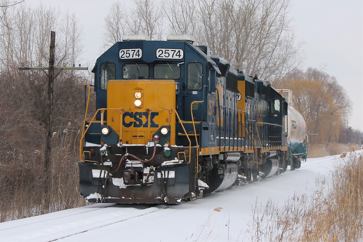 For a railfan my new home is a pretty prime spot, I can stroll out my back yard and catch a fairly unique operation, the problem is trying to time your catch as the CSX tends to sneak up on you.

One of CSX Transportation's few Canadian operations, an industrial job originating in Sarnia approaches St.Clair Blvd. in Corunna after just servicing DuPont to the North of town. 

This particular job uses whats left of the CSX Sarnia Subdivision, which runs all the way to Chatham, but is facing abandonment on the Southern portion if a new operator cannot be found in the coming months. 

Note: The southern portion of the line South of Wallceburg is owned by the Municipality of Chatham-Kent, but the rail has been sold to CP, if an agreement for operation is not made shortly CP can claim the rail and rip it up.