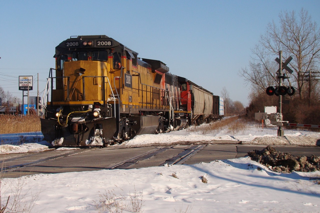 A short four car freight heads across Howard Ave. behind CN 2008 and CN 9616.