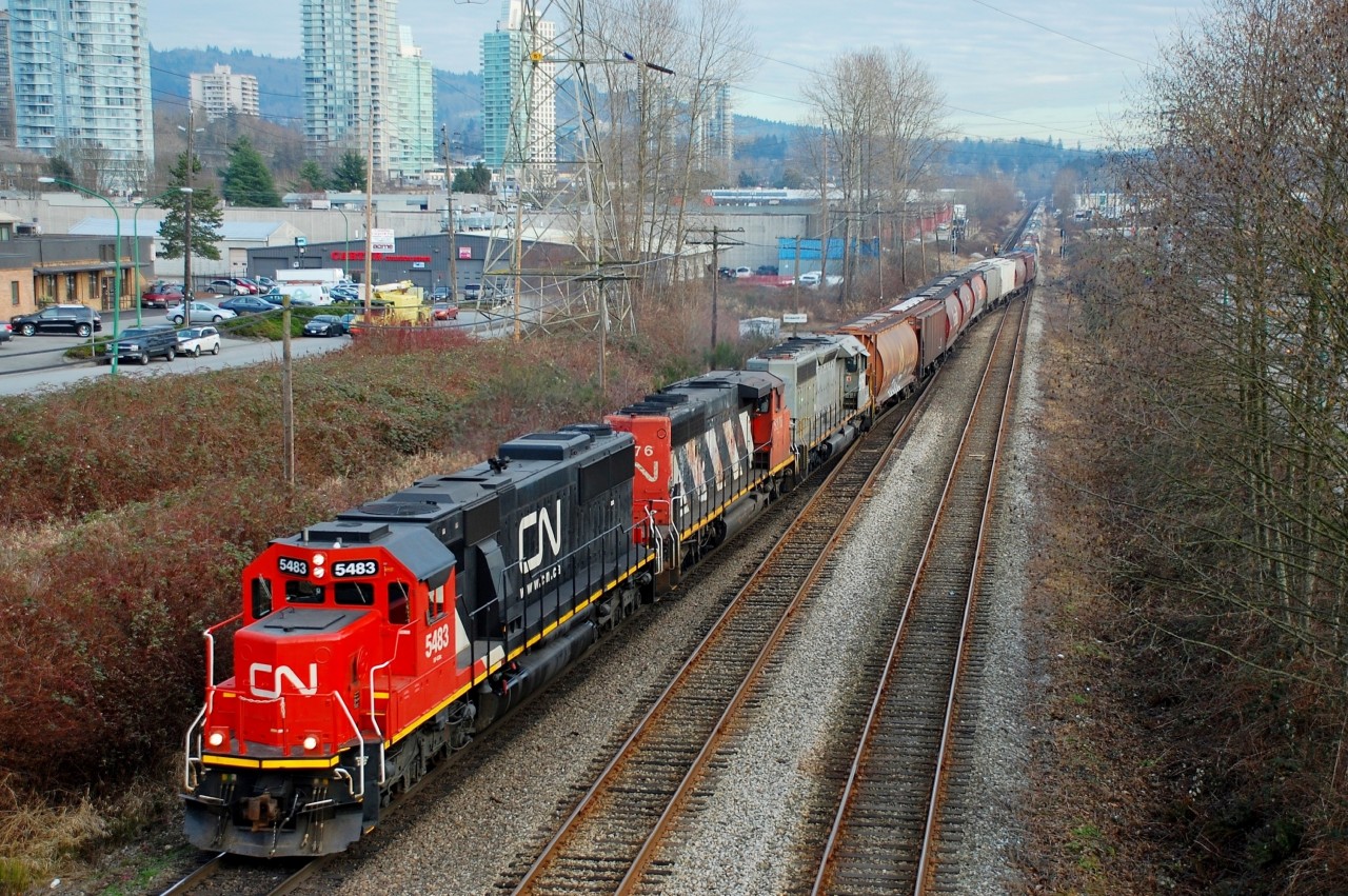 CN 5483 is leading the way through Willingdon Jct as this load of grain is taking the Thornton Tunnel line to North Vancouver. The trailing unit appears to be an unusual SD40-3.