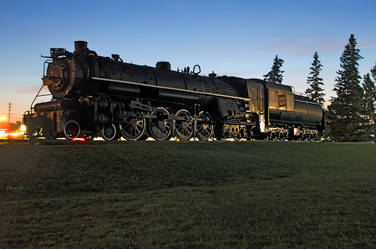 CN 6200 at dusk. CN 6200 has seen better days. It is on the outside grounds of the Canada Science and Technology Museum in Ottawa which has better two preserved 4-8-4's inside.