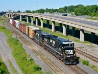 With an elephant style lashup of two standard cab GE's in great paint (NS 8716 & NS 8701), a very late CN 528 heads east through the Turcot area of Montreal. At left is the Lachine Spur, which was once CN's main line through here. It was downgraded to a spur around 1960. 