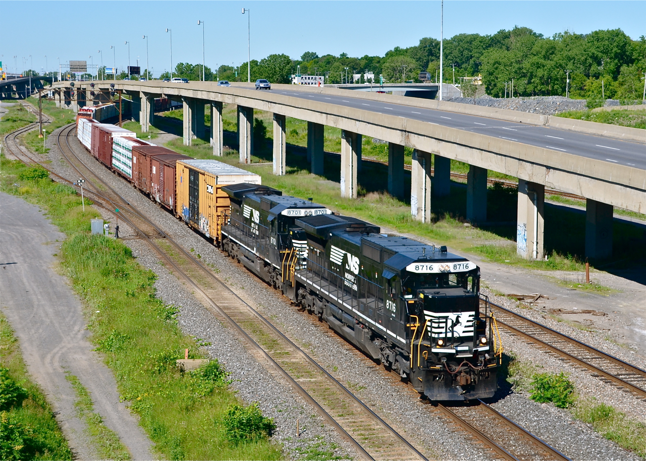 With an elephant style lashup of two standard cab GE's in great paint (NS 8716 & NS 8701), a very late CN 528 heads east through the Turcot area of Montreal. At left is the Lachine Spur, which was once CN's main line through here. It was downgraded to a spur around 1960.