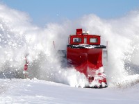 CP 401005 sends snow flying as they bust through the crossing at Thompson Line