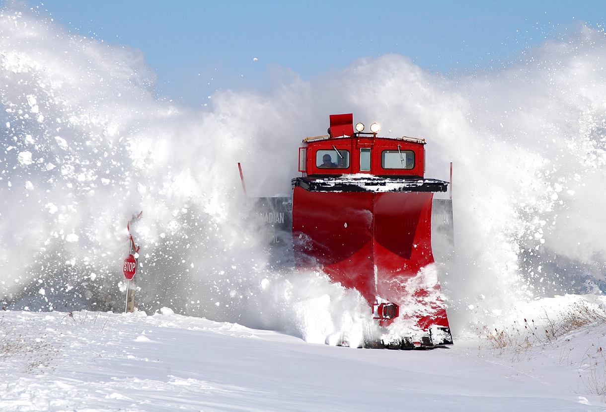 CP 401005 sends snow flying as they bust through the crossing at Thompson Line
