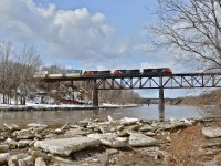 <b>Sometimes you get lucky.</b> I ran out of a friends car (Samuel Thibodeau) and squeezed off just a single shot off before the train sped by. CN 120 heads east through Saint-Léonard-d'Aston with a trio of GE products (CN 2234, CN 2204 & CN 2604) pulling a long string of containers bound for Halifax.