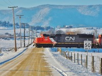 It's a cold afternoon in Spallumcheen as CN 5441 leads this southbound freight across L&A Cross Rd and on towards Vernon.