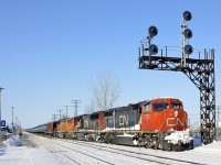 <b>An all-EMD CN 720.</b> CN 720 takes off after having stopped at Dorval Station due to congestion up ahead. Power is two CN SD75I's and a BNSF SD70MAC (CN 5733, CN 5793 & BNSF 8867). CN 720 is a crude oil train destined for Rivière-des-Prairies in Montreal's east end.