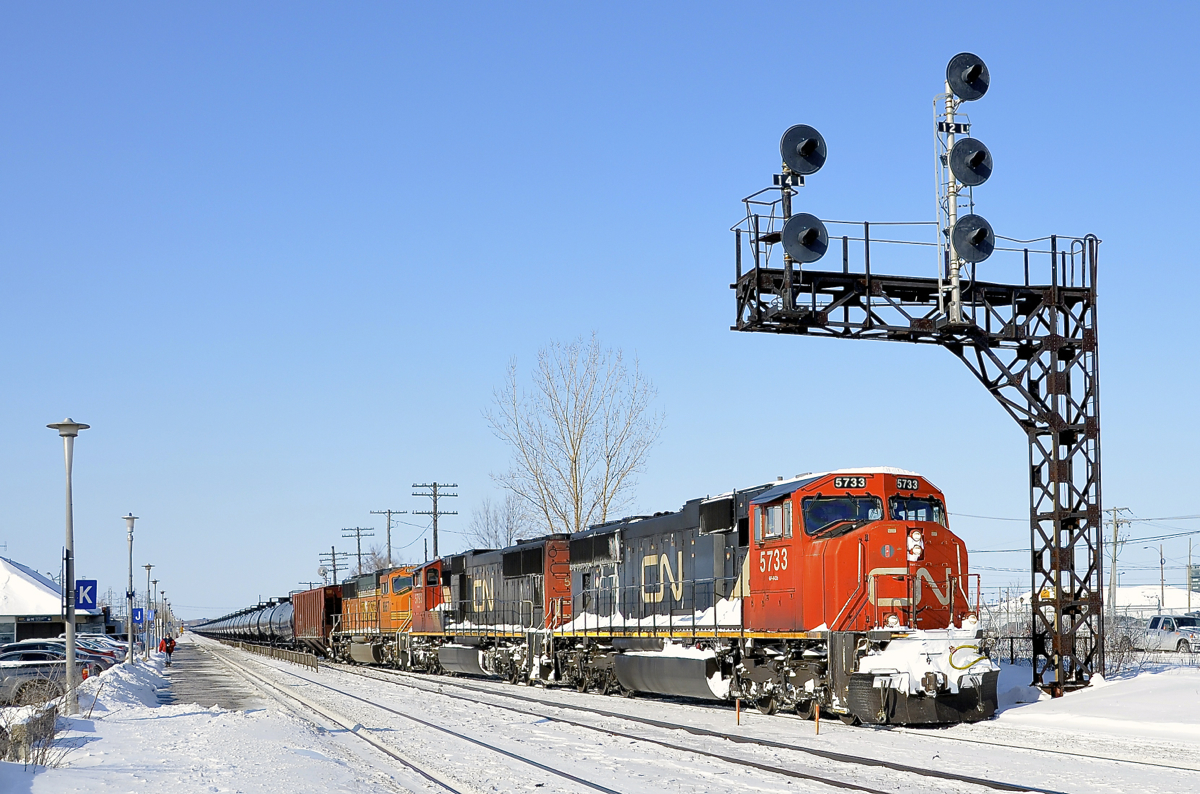 An all-EMD CN 720. CN 720 takes off after having stopped at Dorval Station due to congestion up ahead. Power is two CN SD75I's and a BNSF SD70MAC (CN 5733, CN 5793 & BNSF 8867). CN 720 is a crude oil train destined for Rivière-des-Prairies in Montreal's east end.