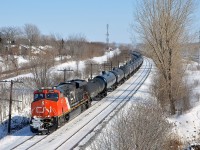 A late CN 305 with CN 2270 at the head end and CN 8021 mid-train heads west through Beaconsfield on Montreal's West Island. 