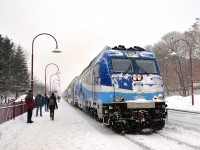 <b>A snowy commute.</b> AMT 112 with dual mode engine AMT 1351 leading is about to stop at Montreal West during a snowy morning rush hour.