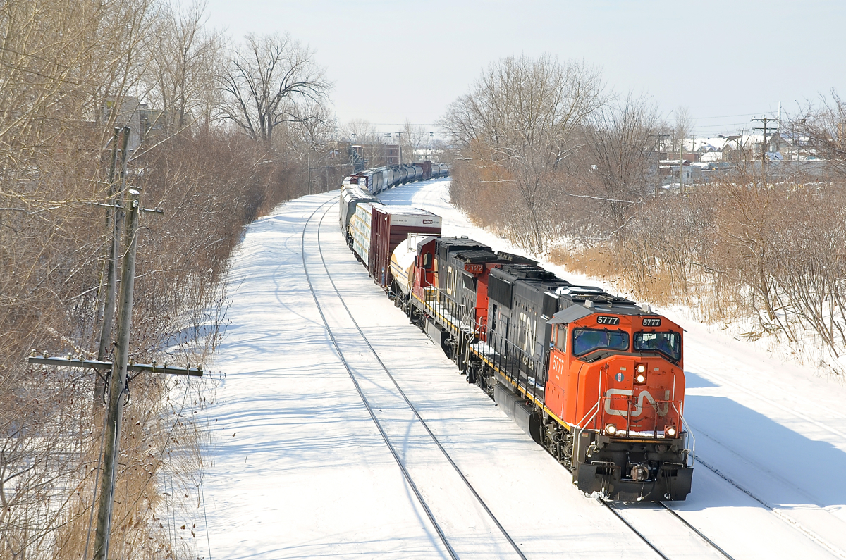 A rather lengthy CN X324 is eastbound with CN 5777 and CN 2122.