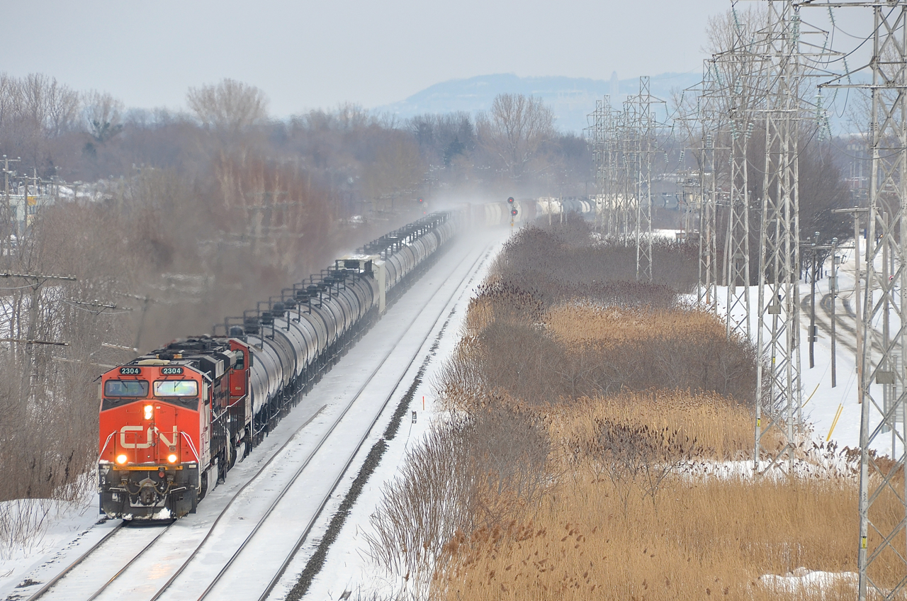 CN 2304 and CN 8956 lead CN 377 through Pointe-Claire on the north track of the Kingstson sub about twenty minutes after CN 305 passed on the south track.