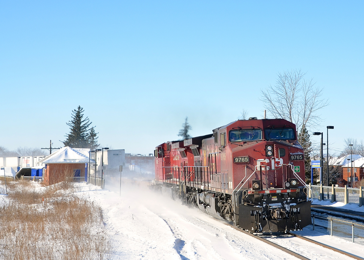 A late CP 132 comes around the curve at Sainte-Anne-de-Bellevue at the western tip of the island of Montreal with CP 9765 & CP 8565.