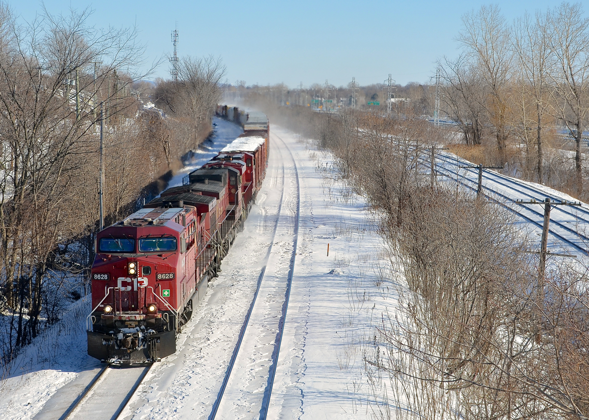 CP 119 has a three pack of CP GE's (CP 8628, CP 8567 & CP 8940) leading a long train as it heads west through Beaconsfield. It would soon come to a stop with a hotbox detector announcing a hot wheel had been detected.