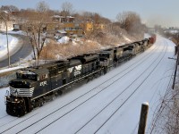 <b>Two days worth of CP 931.</b> CN 529 with two days worth of CP 931 and two days worth of NS power (NS 2732, ex-BN NS 6814, NS 2703 & NS 8840) head west through Montreal West during a very brief period of sunshine. Waving is conductor and railfan Nicolas Houde.