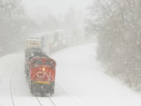 <b>Limited visibility.</b> CN 120 is partially obscured by blowing snow as it heads east with CN 8926, CN 8876 & CN 5657.