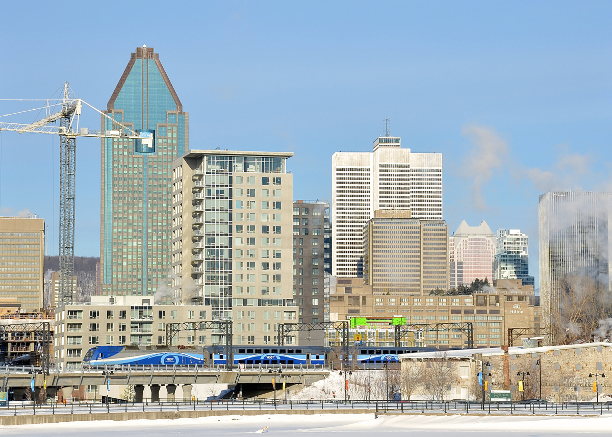 Towards downtown Montreal. AMT 1354 is pushing AMT 809 towards Montreal's Central Station at the tail end of the morning rush hour. In the background is downtown Montreal, including Place Ville-Marie, the tallest building behind the second coach.