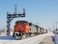 CN's first four SD60F's (CN 5500-5503) are alternately known as SD50AF's and were numbered 9900-9903 from 1985 to 1988. They differ from the rest of the SD60F's by having high mounted numberboards, as did their SD50F predecessors (all now off of CN's roster). Here SD50AF CN 5502 leads a GE cowl (CN 2402) through Dorval on a brutally frigid morning.