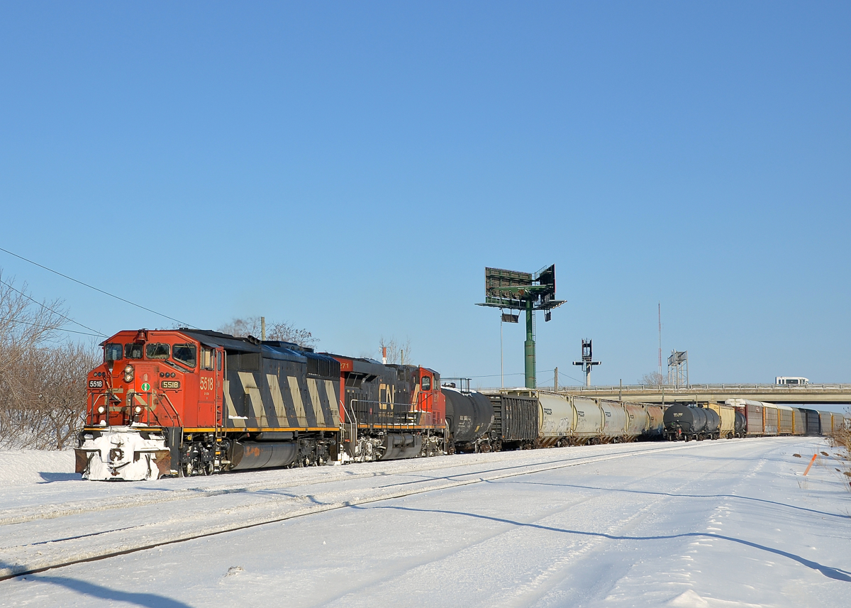 CN 527 and CN X310. CN 527 with CN 5518 and CN 2271 is about to leave Southwark Yard. At right is the tail end of CN X310 which just entered the yard.