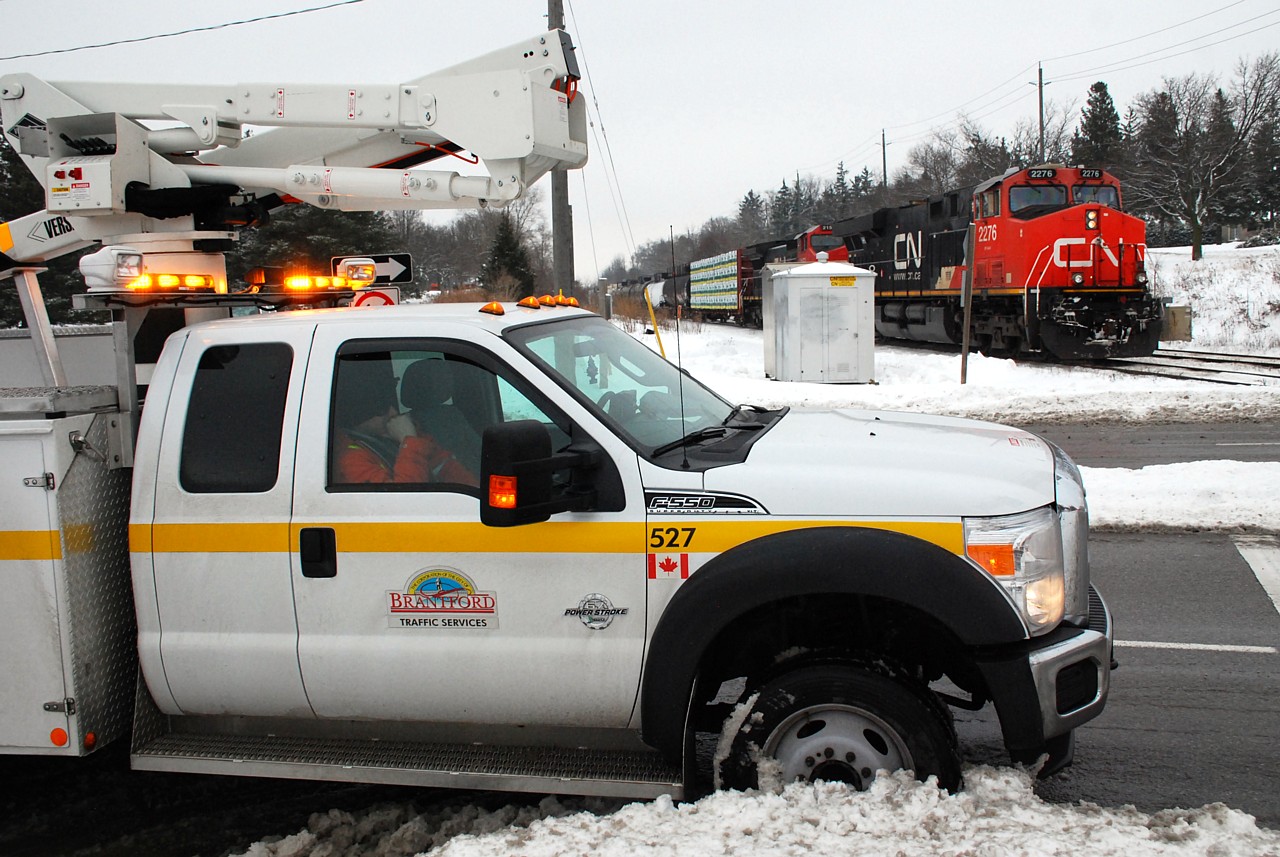 CN train 385, having trouble with CN 2153, stalled on the grade just east of the Hardy Road railway crossing. CN 580 with CN 7081 attempted and failed to push the train. The City Traffic Department was called because the traffic signal at Hardy Road and Paris Road was not cycling because it was stuck in “railway pre-emption” with 385 stopped on the circuit for the railway crossing signals. They ended up backing 385 off the crossing circuit; I don’t know what they ended up doing to get the train moving again.