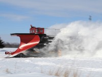 Poof.......blasting through a drift, throwing the snow upwards and sidewards.