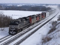 NS 2703 leads CN train 373 through Newtonville after a fresh snowfall. Headlights were dimmed as they were about L350.